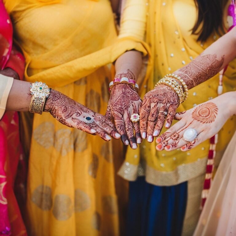 indian-woman-holds-her-hands-covered-with-mehndi-wearing-bracelets-her-chest